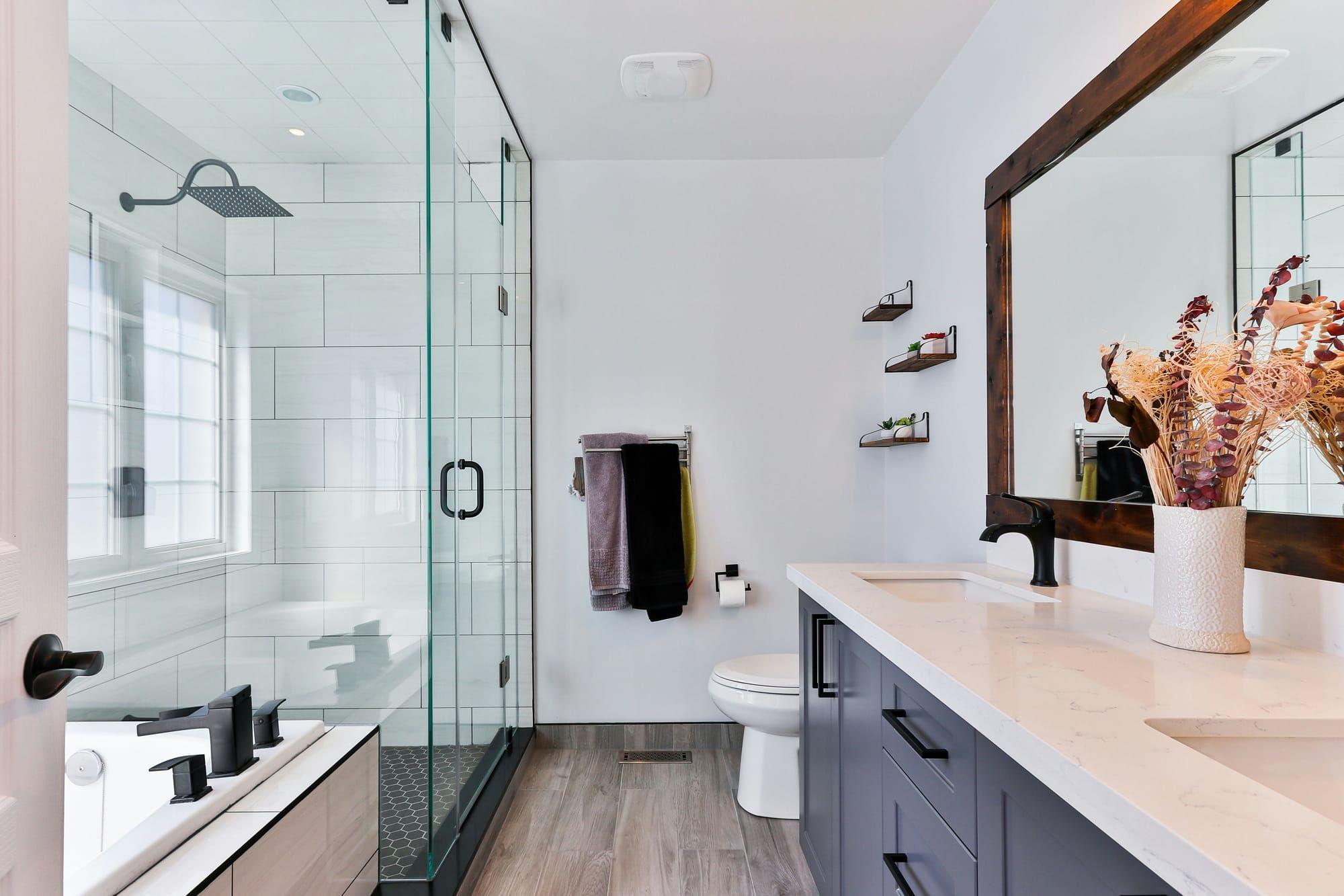 Bathroom with glass shower enclosure and wood-look flooring