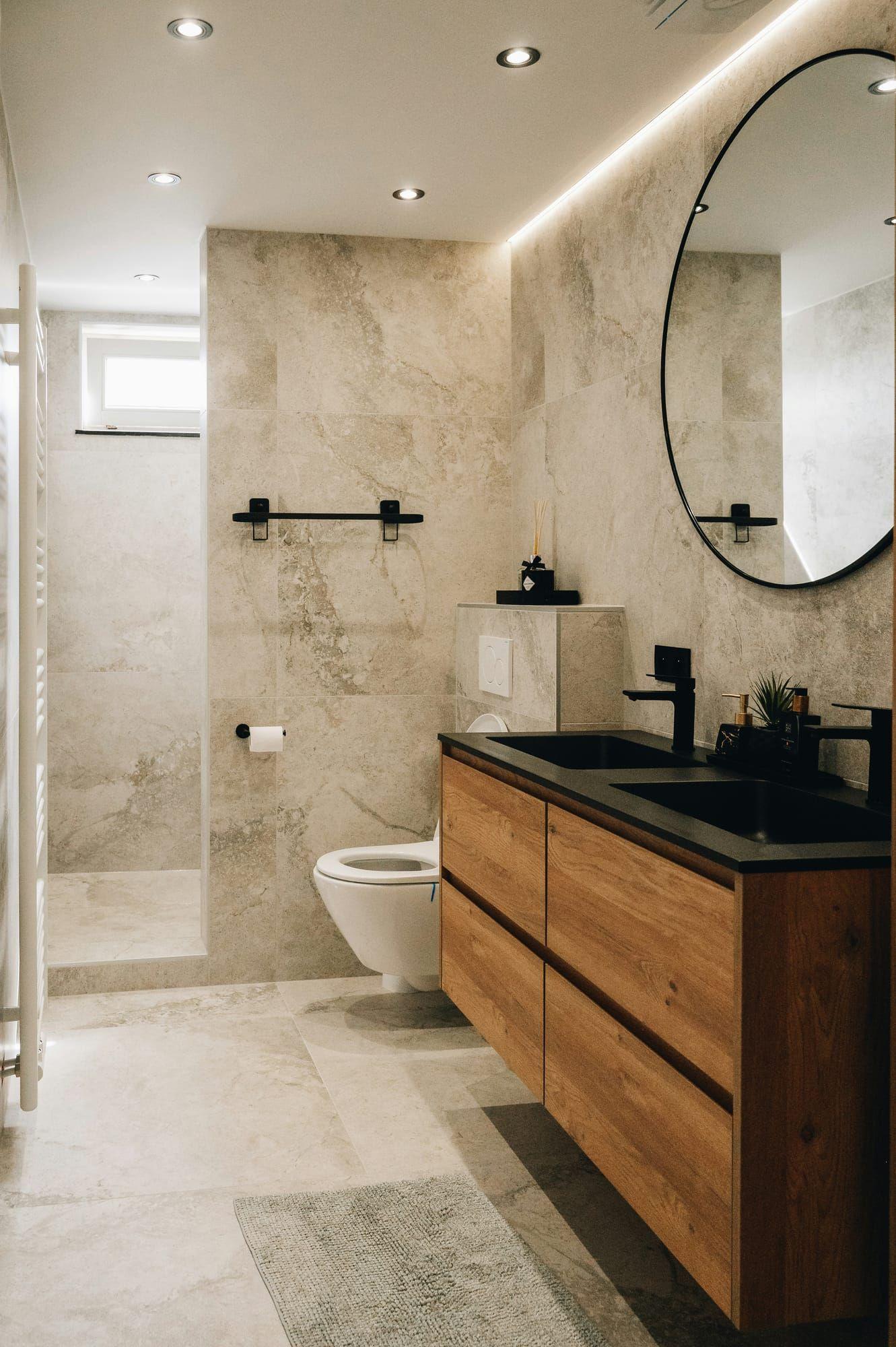 Bathroom with large-format stone tile and dual-sink wood vanity