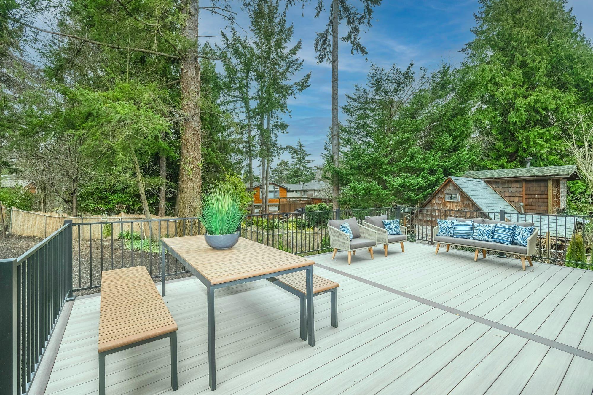 Large composite deck with dining table and lounge seating