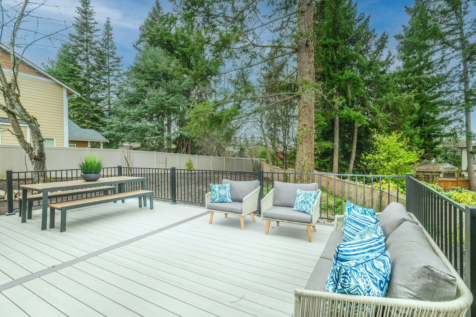 Composite deck with outdoor lounge furniture and metal railing