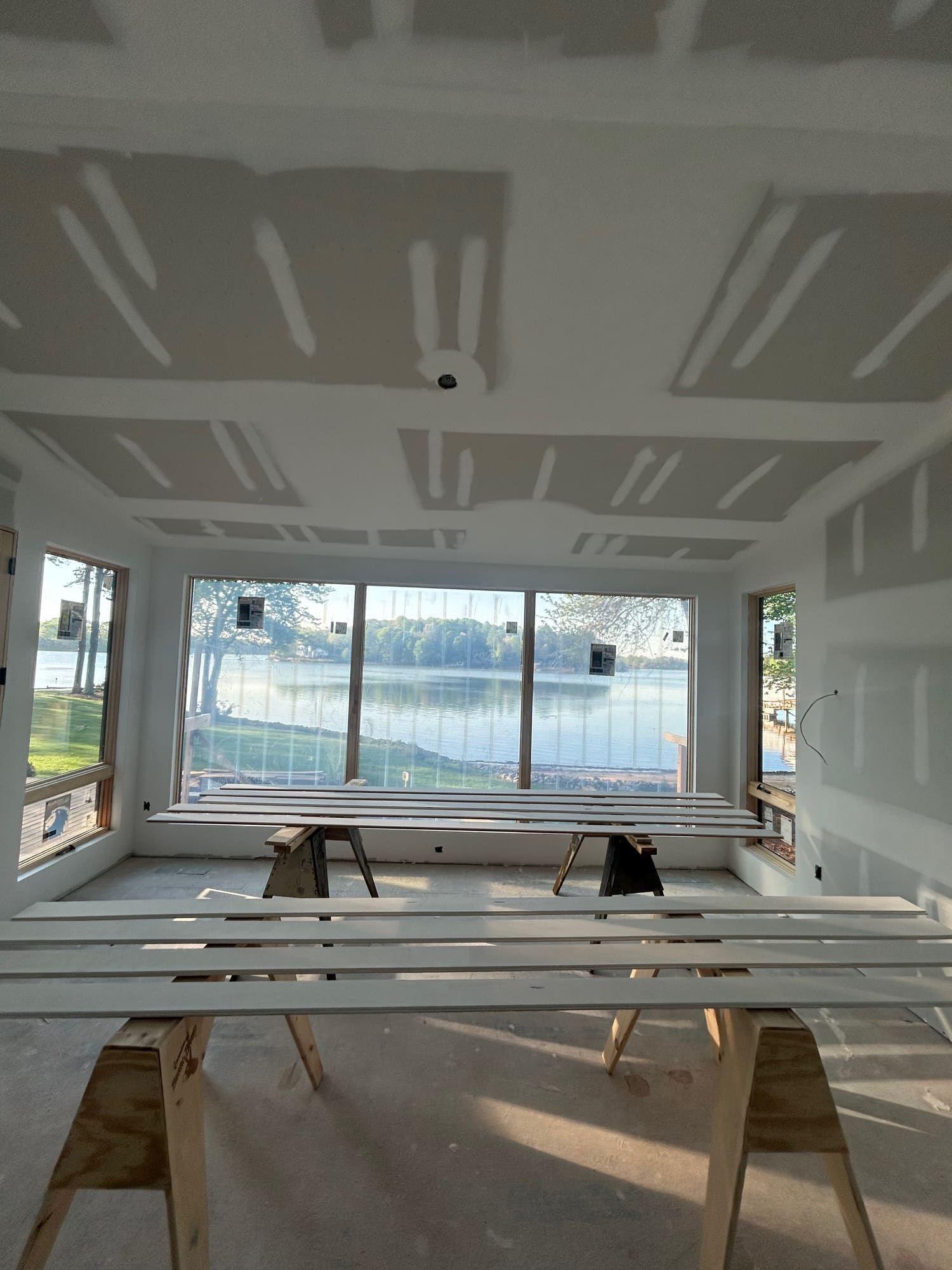 Finished drywall ceiling in sunroom with lake view