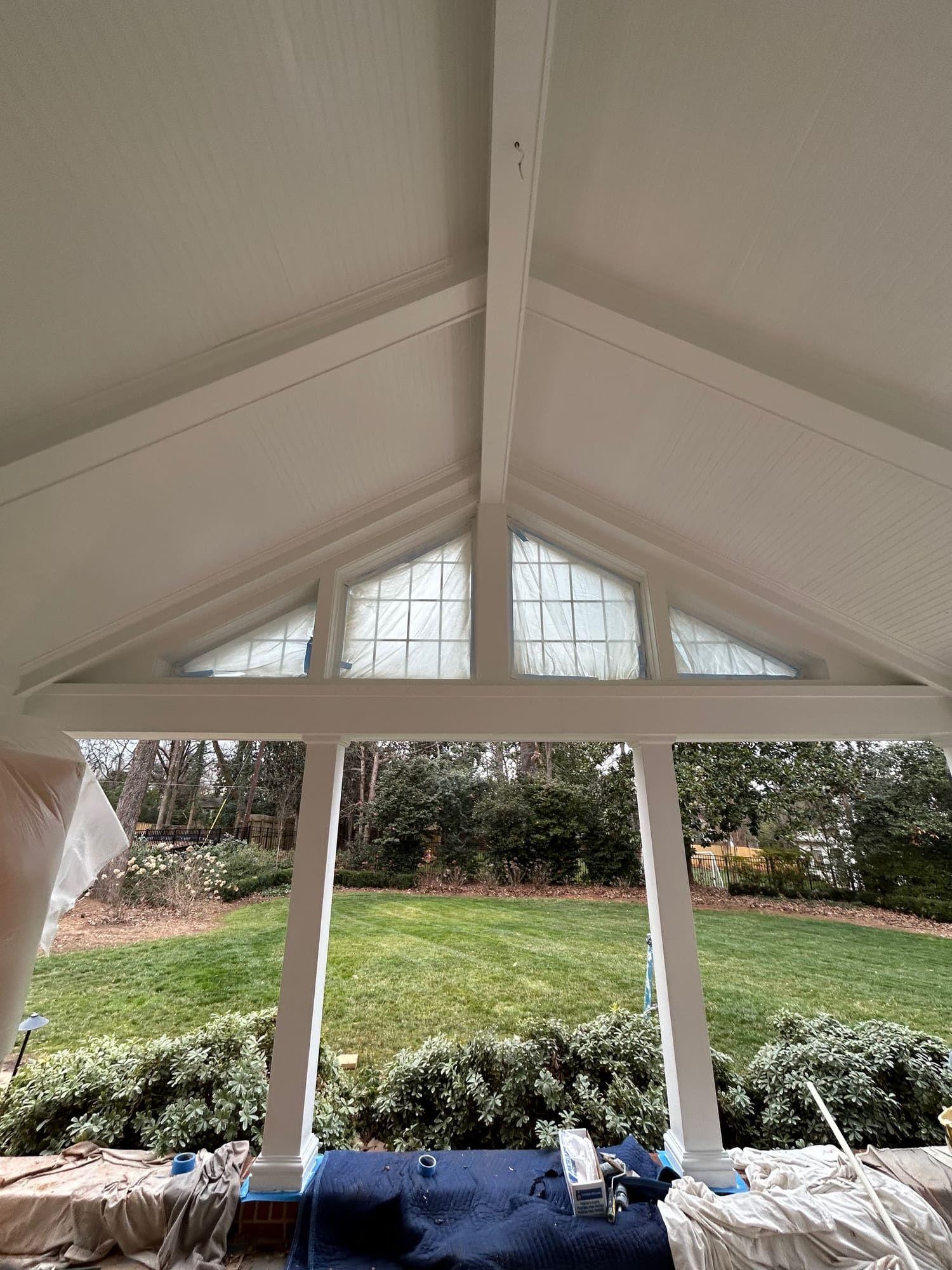 White painted porch gable and column trim with backyard view