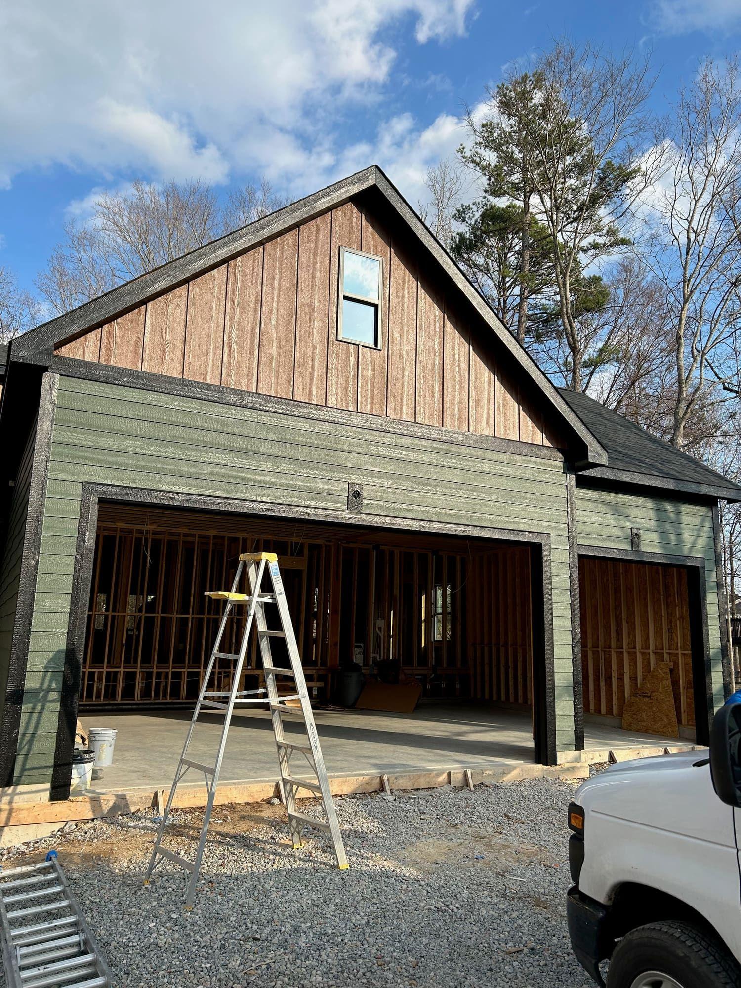Two-tone exterior paint, green garage with wood-look gable in progress