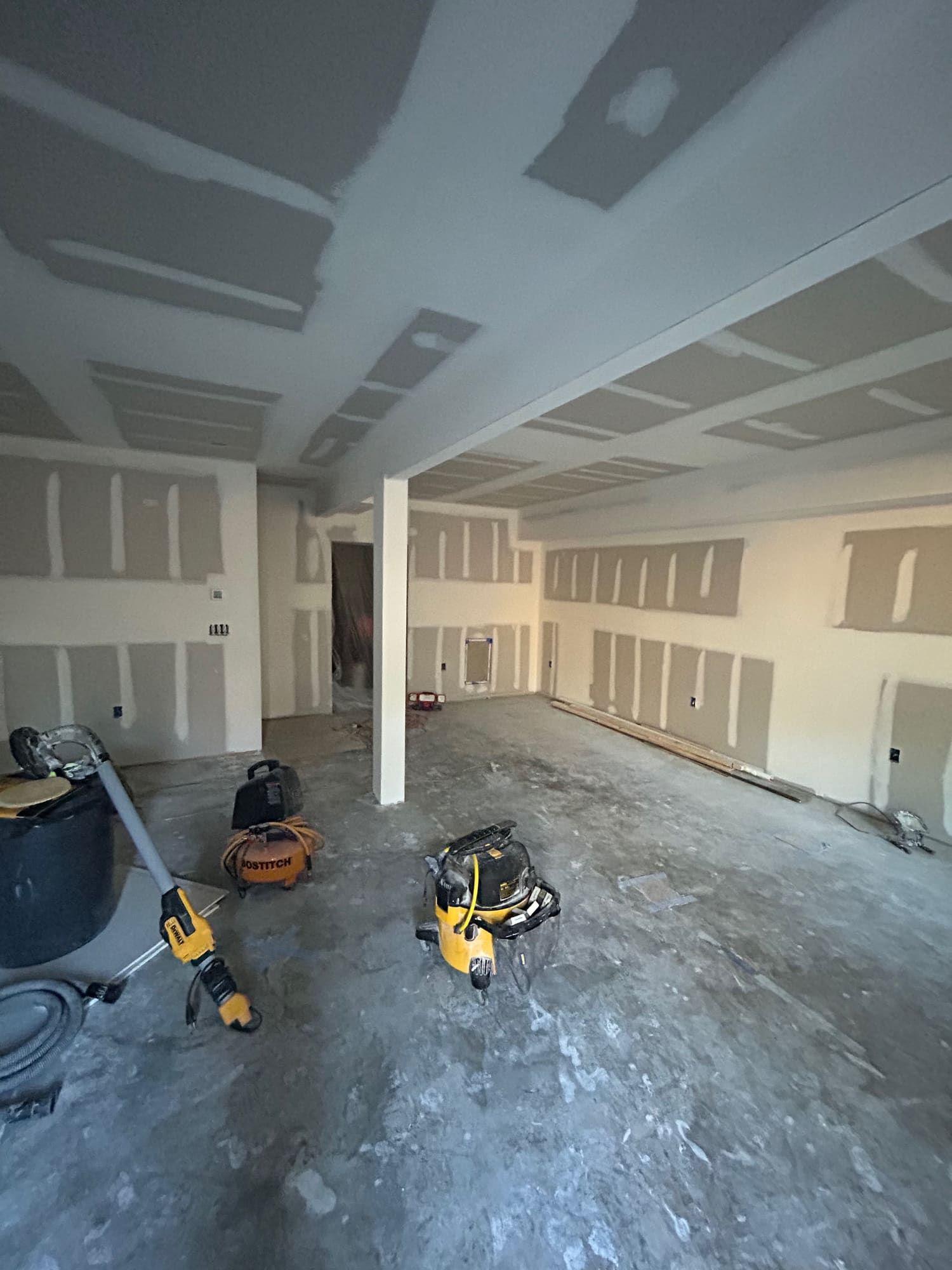 Garage conversion framed and drywalled into finished room