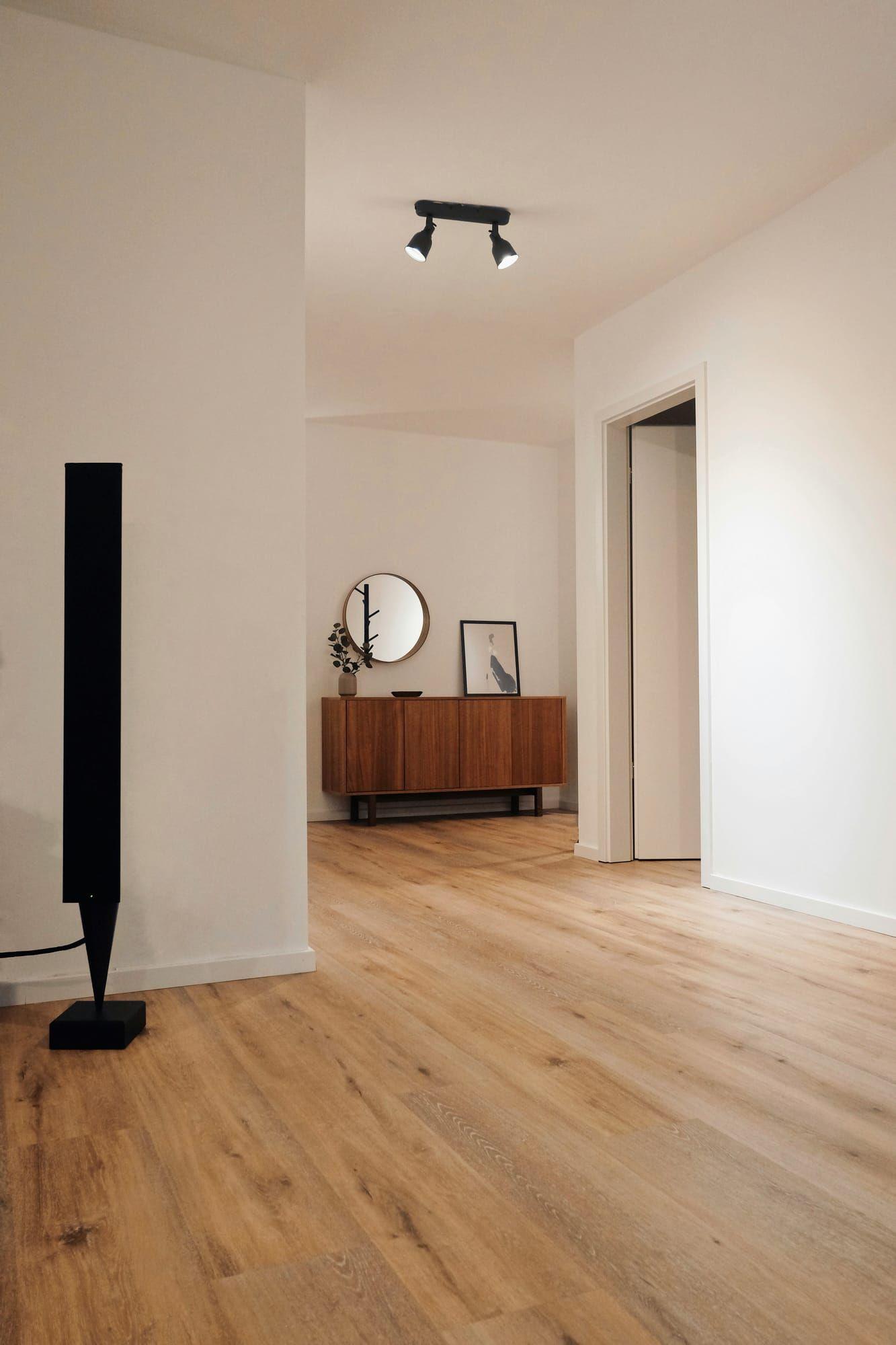 Hallway with light wood-look plank flooring